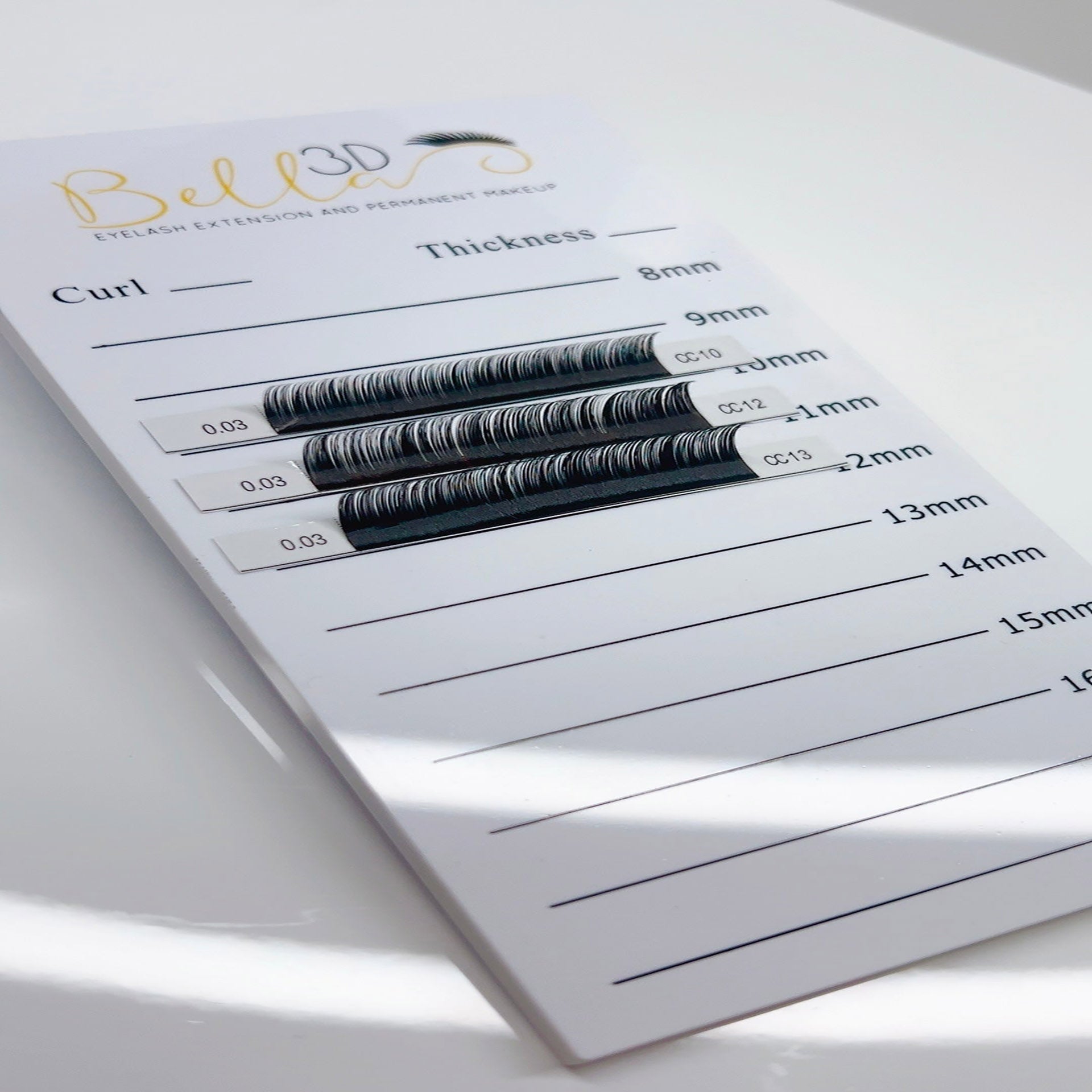 Bella 3D Acrylic Lash Tile displaying various curled and thick eyelash extensions for professional use.