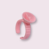 Pink plastic adhesive glue rings used for holding eyelash extension adhesive during application