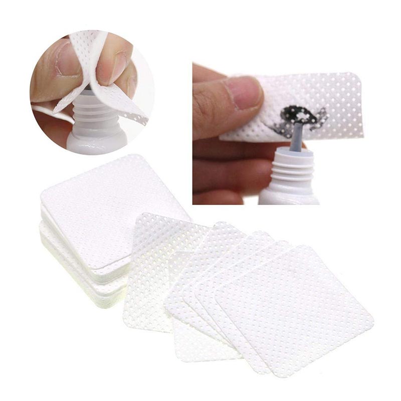 White textured sheets used to clean glue residue from adhesive nozzles with Adhesive Nozzle Wipes.