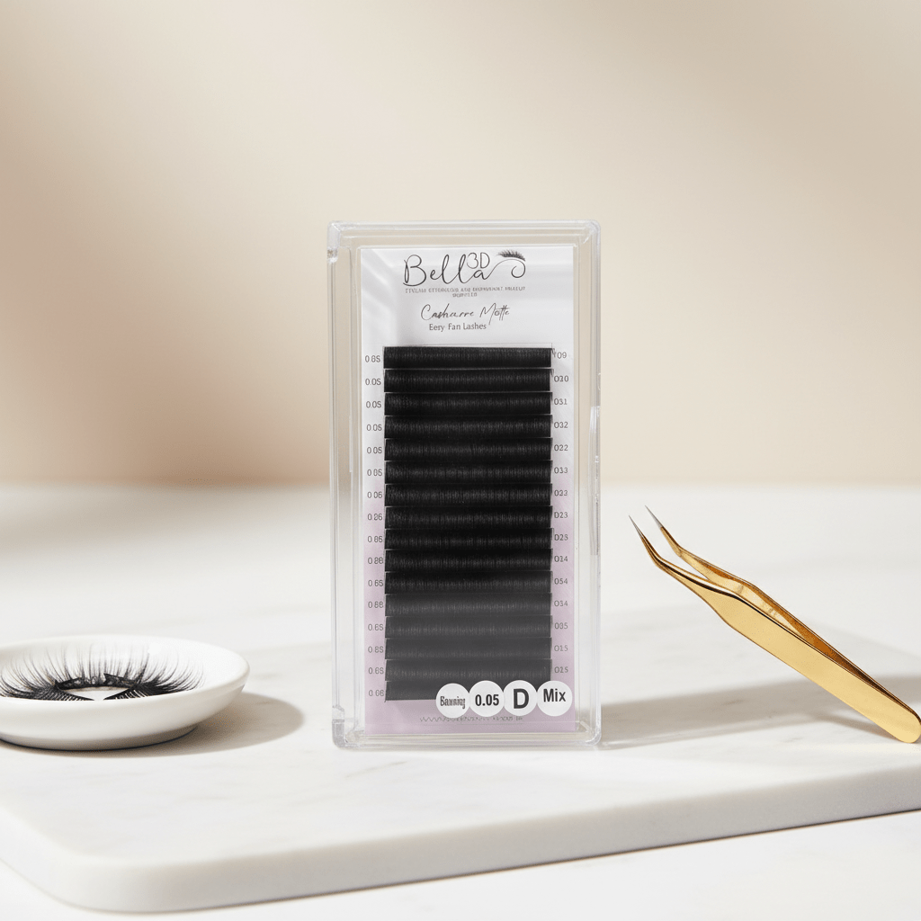 Cashmere Matte Easy Fan Lashes - 0.05 in black with gold tweezers and eyelash extensions on white surface
