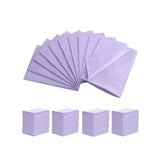 Purple disposable Dental Bibs neatly stacked and fanned out, designed for professional hygiene use.