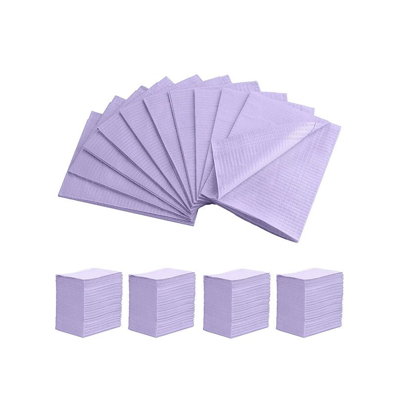 Purple disposable Dental Bibs neatly stacked and fanned out, designed for professional hygiene use.