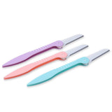 Three colorful Disposable Facial Razors in purple, pink, and blue with protective blade covers on a white background