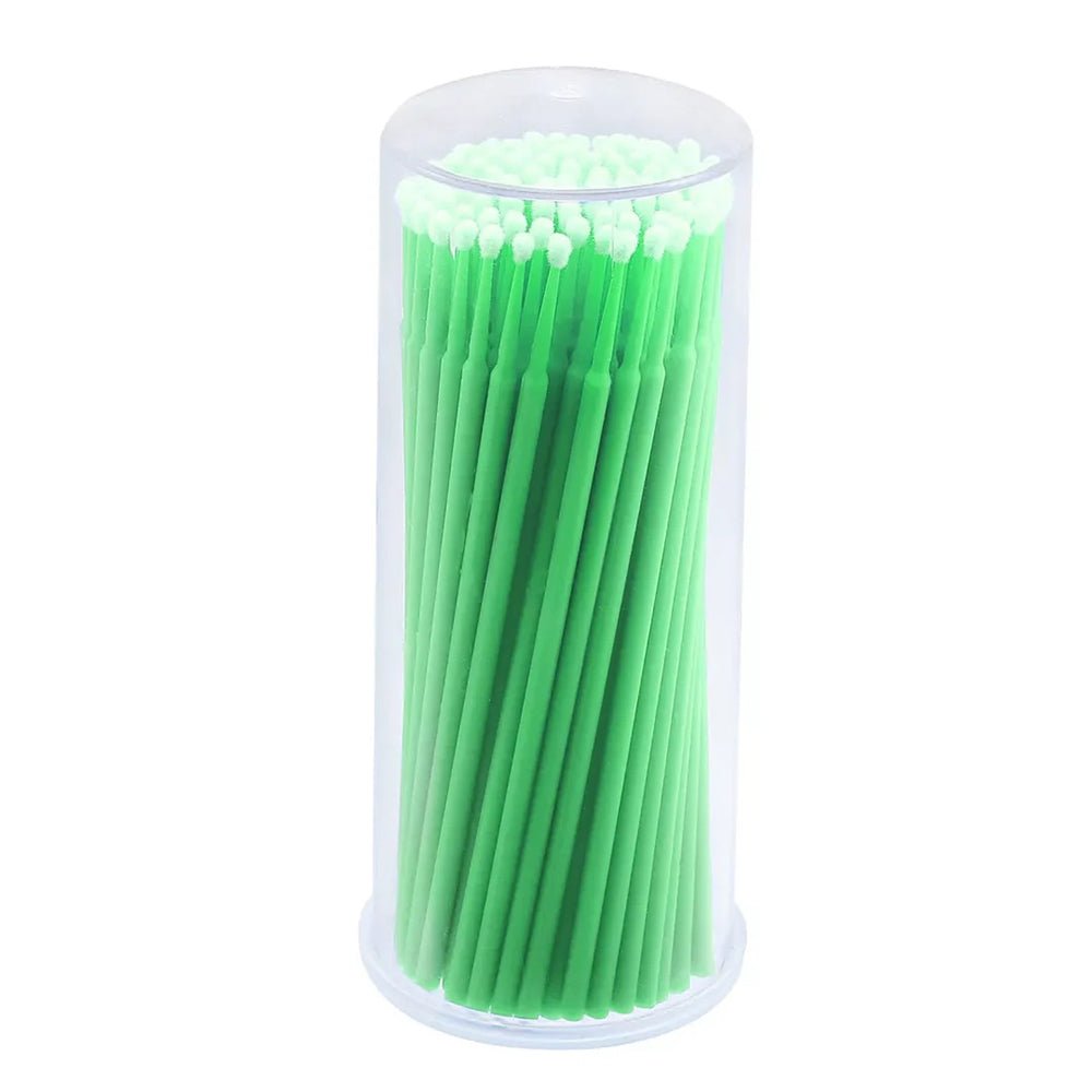 Disposable Micro Tip Applicators with green handles neatly packed in a clear cylindrical container for precision application.