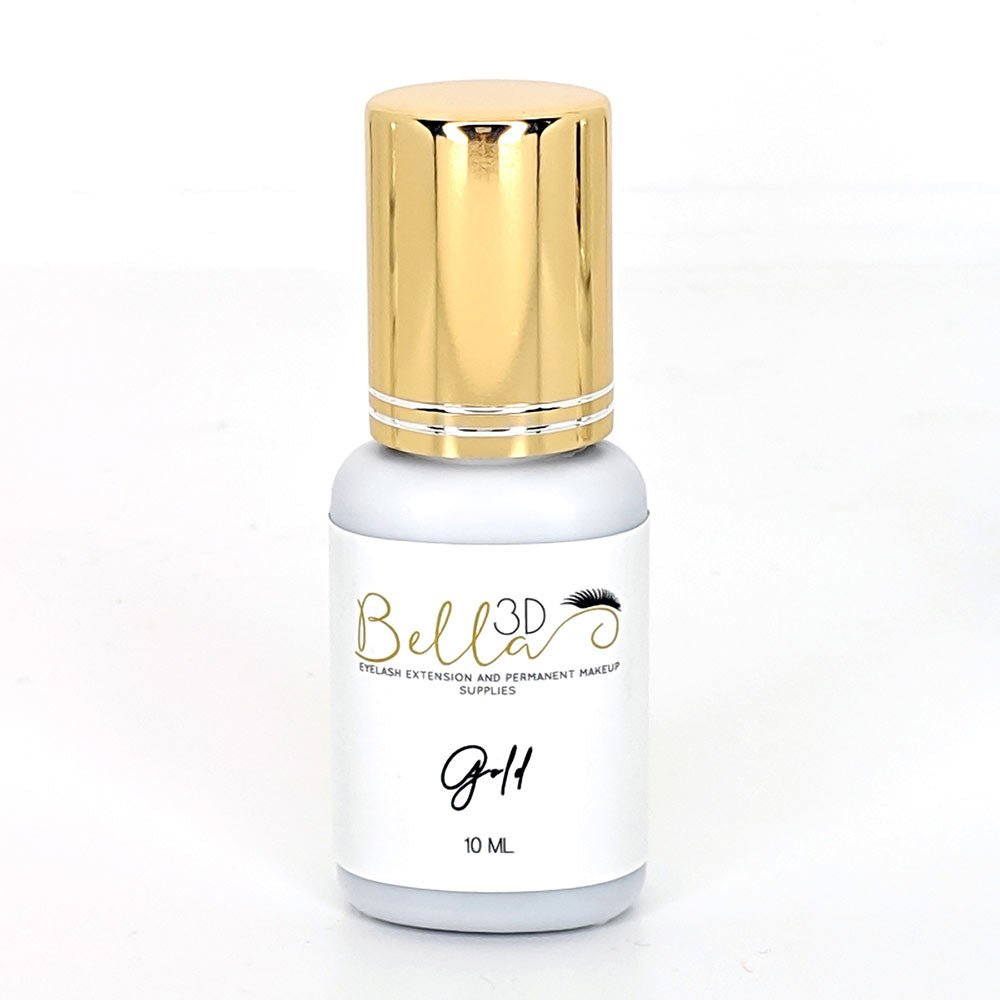 Gold Adhesive in a white and gold bottle designed for eyelash extension and permanent makeup supplies.