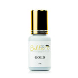 Bottle of Gold Adhesive with gold cap designed for eyelash extension and permanent makeup supplies.