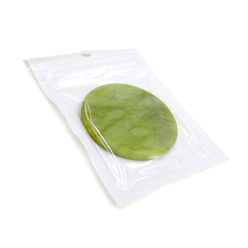 Jade Stone in clear plastic packaging, smooth green stone used for eyelash extension accessories or microblading tools