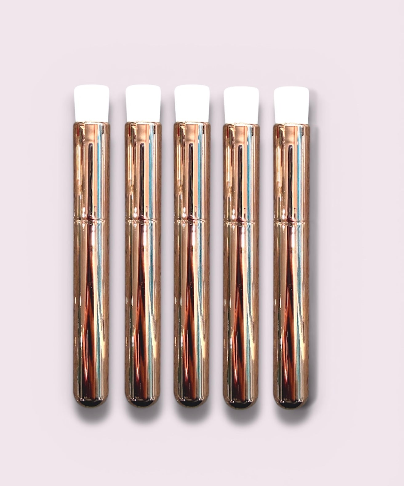 Set of five rose gold Lash Cleansing Brushes (Retail Pack) with white silicone tips for eyelash extension care.