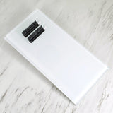 Clear rectangular Lash Glass Tiles on marble surface with two sets of black eyelash extensions