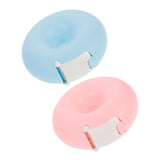 Two pastel-colored Lash Tape Dispensers in blue and pink with built-in tape cutters for eyelash extensions use