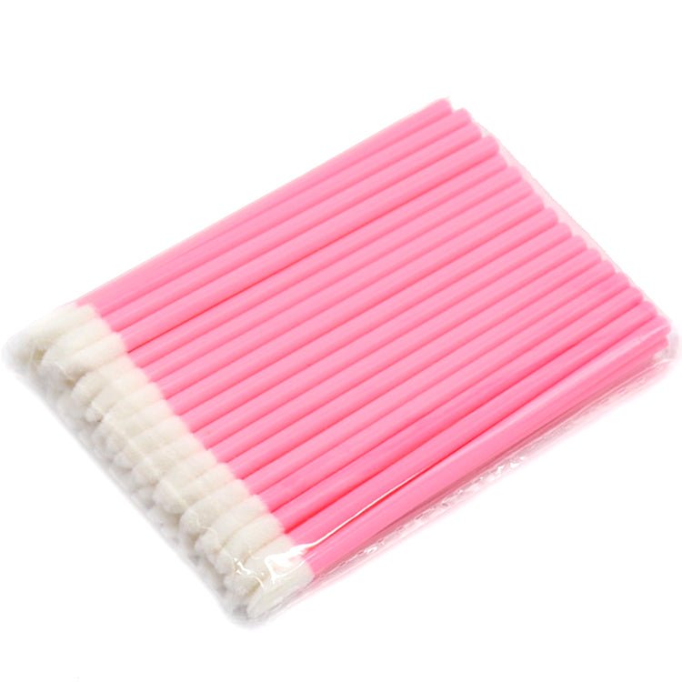 Bundle of pink Lip Wands with soft white applicator tips for precise cosmetic and eyelash extension use