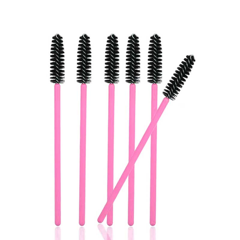 Six pink handled mascara wands with black bristles arranged upright with one wand angled to the side, Mascara Wands
