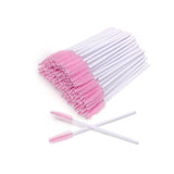 Bundle of pink-ended Mascara Wands with white handles, used for applying eyelash extension adhesive and beauty treatments.