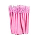 Set of pink disposable Mascara Wands with soft bristles for precise eyelash extension application and grooming.