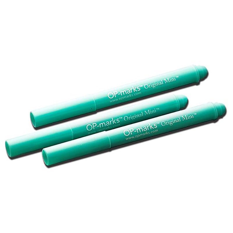 Three green Original Mini Marker pens arranged diagonally on a white background