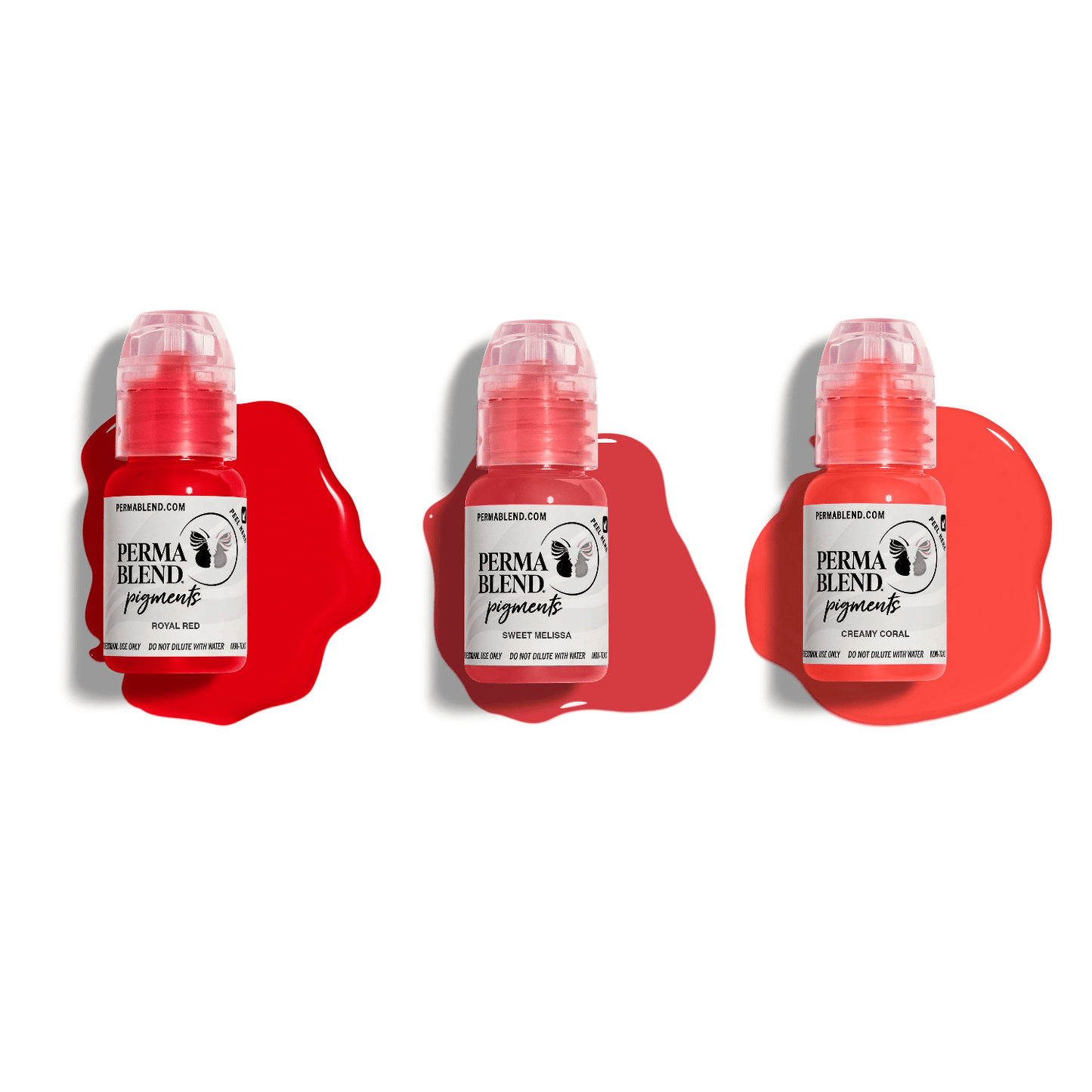 Three small bottles of PermaBlend Lip Pigments in red, coral, and sweet melissa shades with pigment smears behind each bottle.