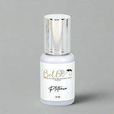 Small white bottle with shiny silver cap containing Bella 3D Platinum Adhesive for eyelash extensions and makeup supplies
