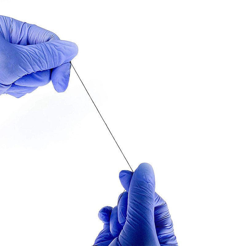 Hands wearing blue gloves holding and stretching a thin black Pre-Inked Mapping String on a white background