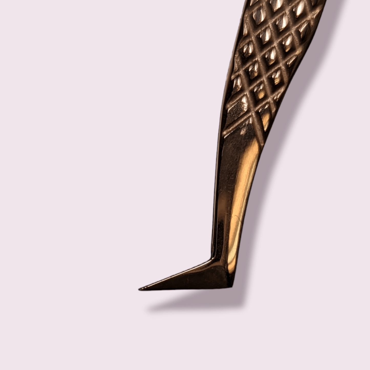 Close-up of a textured metal angled tip tool used for eyelash extensions called #SBD9 Volume Tweezer