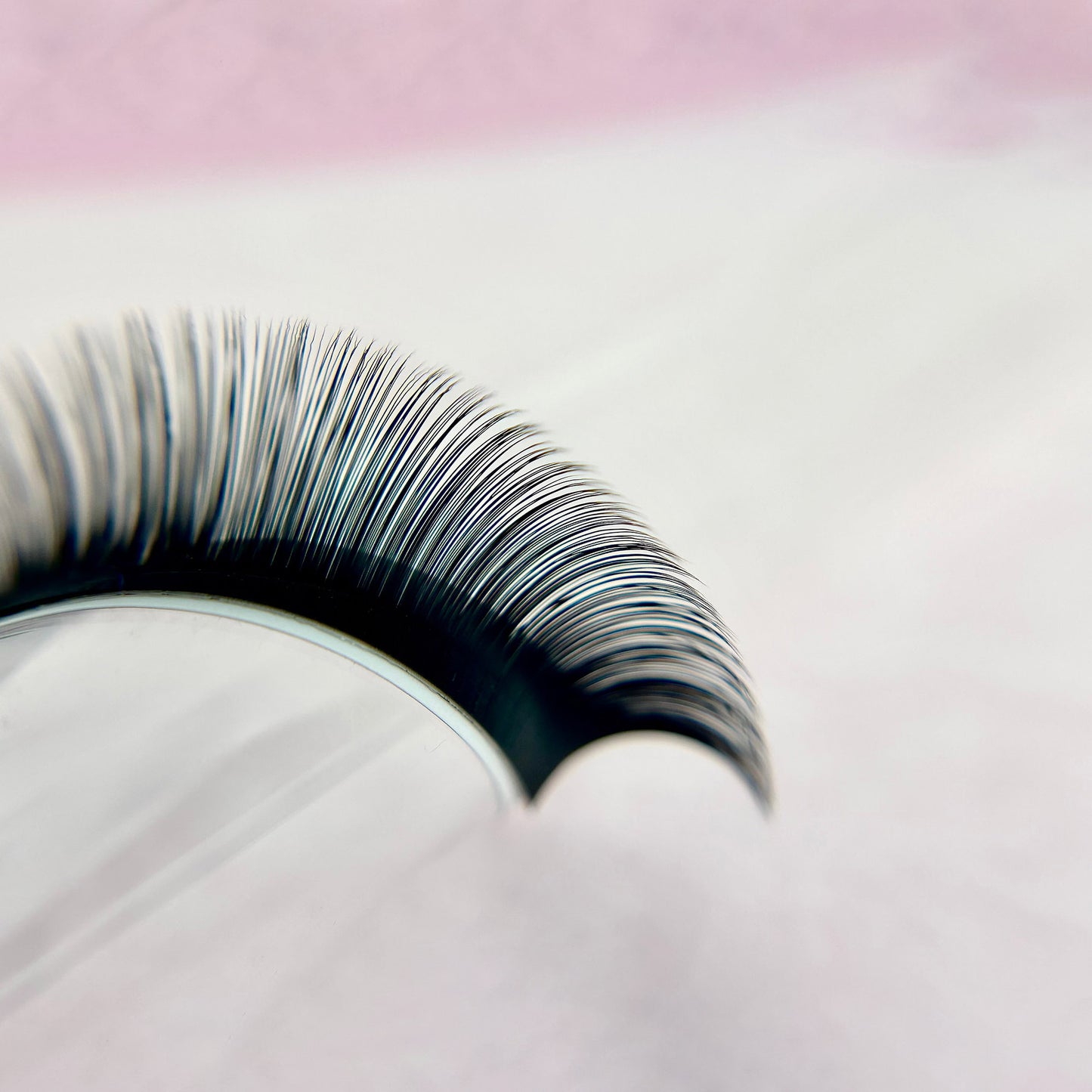 Close-up of curved eyelash extensions showcasing fine, natural fibers from Signature Silk Collection - 0.03