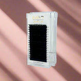 Signature Silk Collection - 0.03 eyelash extensions in a clear case with black lashes displayed against a pink background