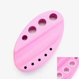 Pink Silicone Ink Cup Holder with multiple sized holes for organizing eyelash extension accessories and adhesives