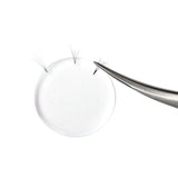 Silicone Lash Pad with tweezers holding eyelash extensions used for eyelash extension accessories and adhesive application