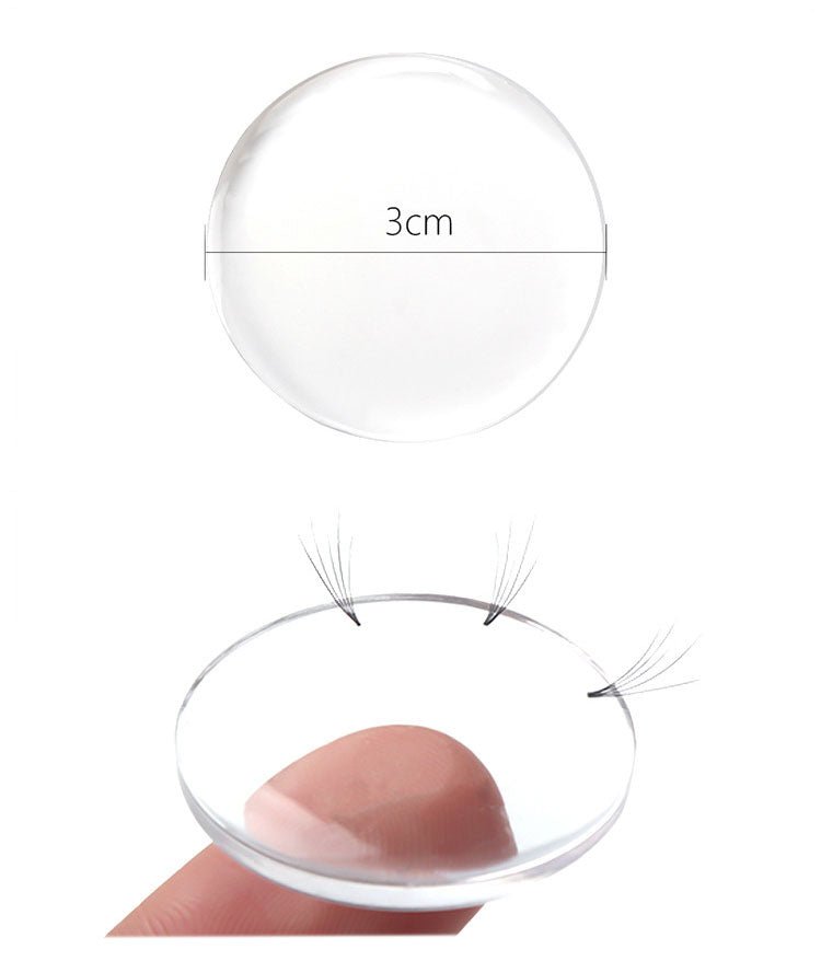Silicone Lash Pad held on finger with eyelash extension clusters on clear 3cm silicone surface for easy use