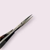 Close-up of stainless steel Straight Spring Scissors with pointed tips on a pale background