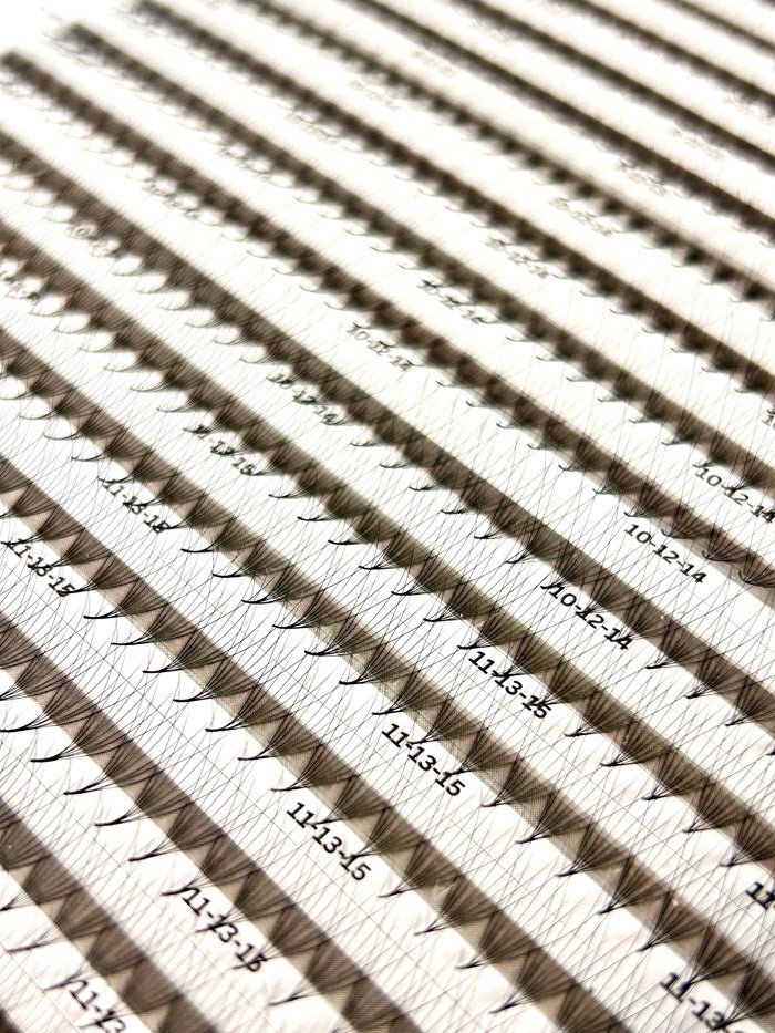 Close-up of multiple Wispy Promade Fans 8D | 0.05 CC eyelash extension fans arranged in rows with size labels